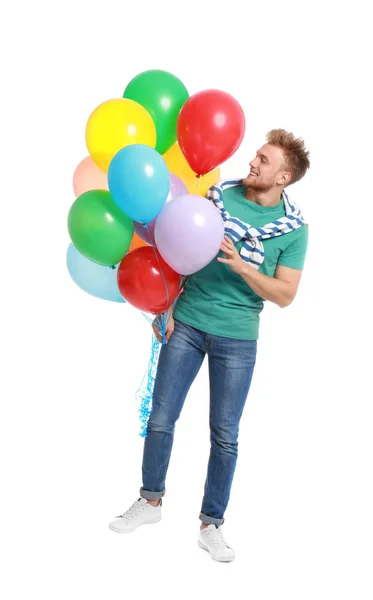 Joven sosteniendo racimo de globos de colores sobre fondo blanco — Foto de Stock