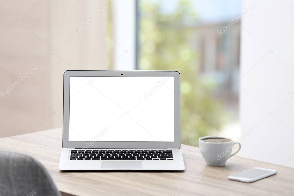 Modern laptop on desk in room. Home workplace