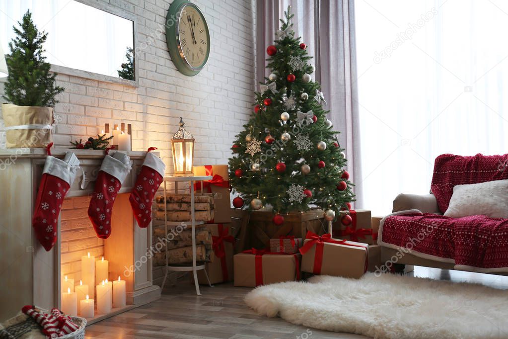 Stylish interior with beautiful Christmas tree and decorative fireplace