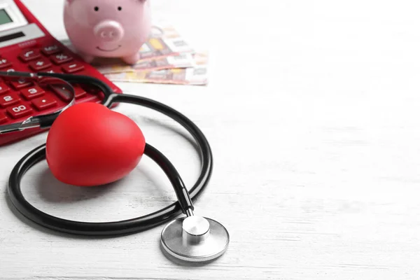 Stethoscope and red heart on white wooden surface, space for text. Health insurance concept — 스톡 사진