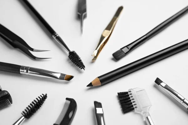 Set of professional eyebrow tools on white background