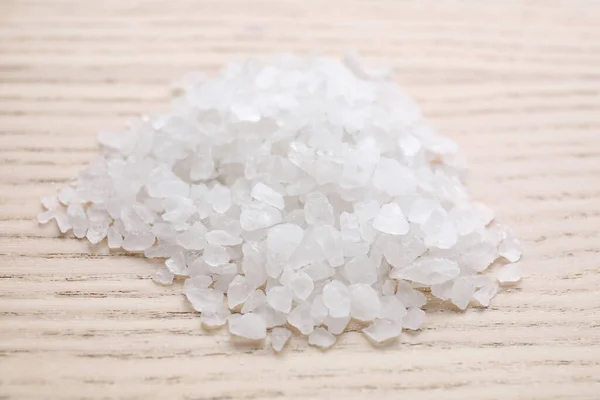 Haufen weißes Meersalz auf Holztisch, Nahaufnahme. Wellness-Behandlung — Stockfoto