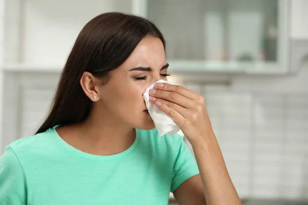 Jovem mulher que sofre de alergia na cozinha — Fotografia de Stock