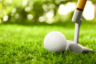 Yeşil sahada golf sopası ile golf topuna vurmak
