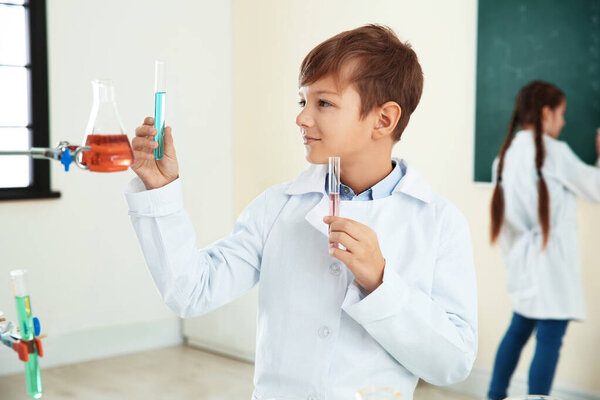 Smart pupil with test tubes in chemistry class