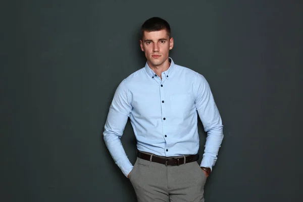 Portrait of handsome young man on dark background — Stock Photo, Image