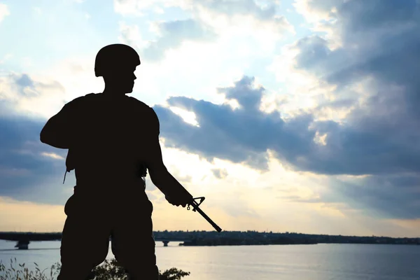 Soldier with machine gun patrolling outdoors. Military service — Stock Photo, Image