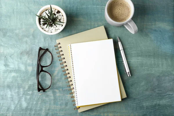 Flat lay composition with office stationery and cup of coffee on wooden table. Space for design — Stock Photo, Image