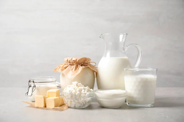 Different delicious dairy products on light table — Stock Photo, Image