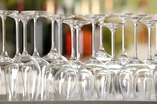 Empty glasses on table against blurred background — Stock Photo, Image