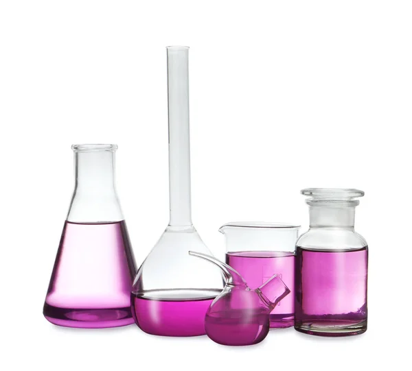 Laboratory glassware with purple liquid on white background — Stock Photo, Image