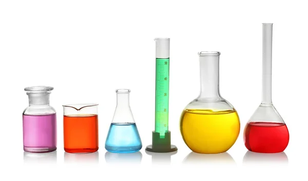 Laboratory glassware with colorful liquids on white background — Stock Photo, Image