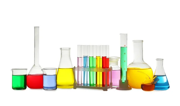 Laboratory glassware with colorful liquids on white background — Stock Photo, Image