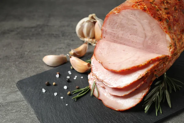 Slate plate with delicious ham on grey table, closeup. Space for text — Stock Photo, Image