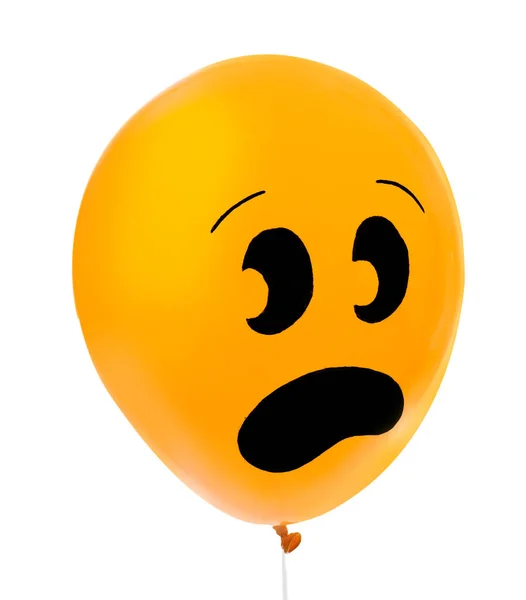 Orange balloon with drawing of scared face on white background. Halloween party — Stock Photo, Image