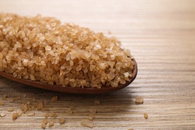 Tahta masadaki spa temizleme işlemi için tuzlu ahşap kaşık, yakın plan.