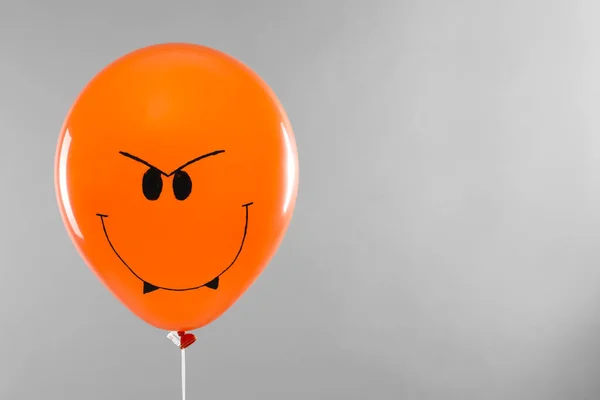 Spooky balloon for Halloween party on light grey background, space for text