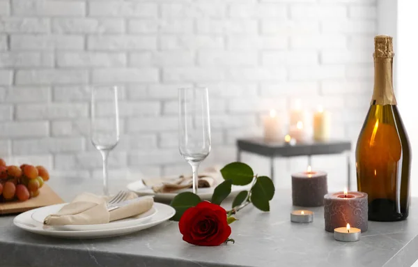 Configuração de mesa romântica com velas em chamas dentro de casa — Fotografia de Stock