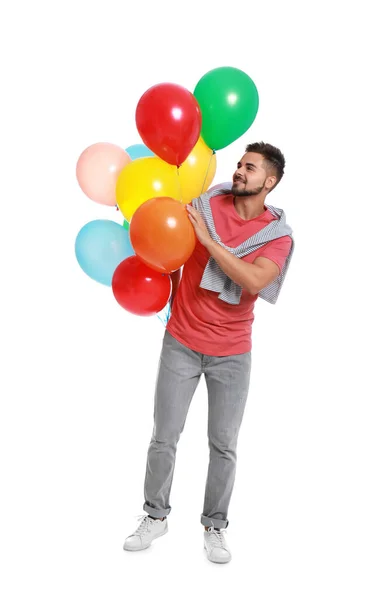 Ung man som håller gäng färgglada ballonger på vit bakgrund — Stockfoto