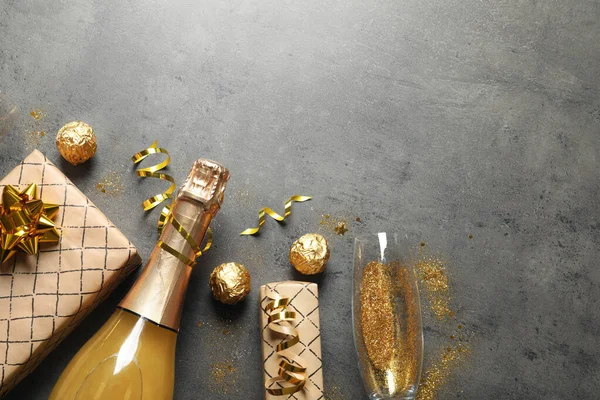 Плоская композиция с бутылкой шампанского для празднования на сером каменном фоне. Пространство для текста — стоковое фото