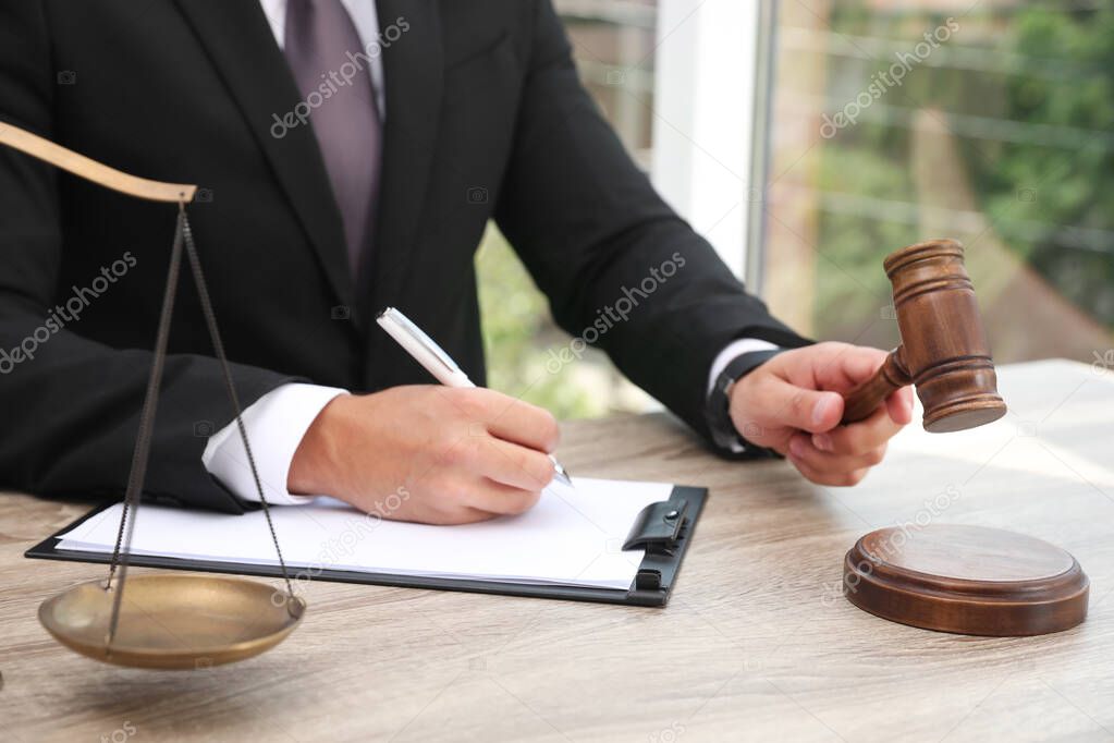 Judge working at wooden table indoors, closeup. Criminal law