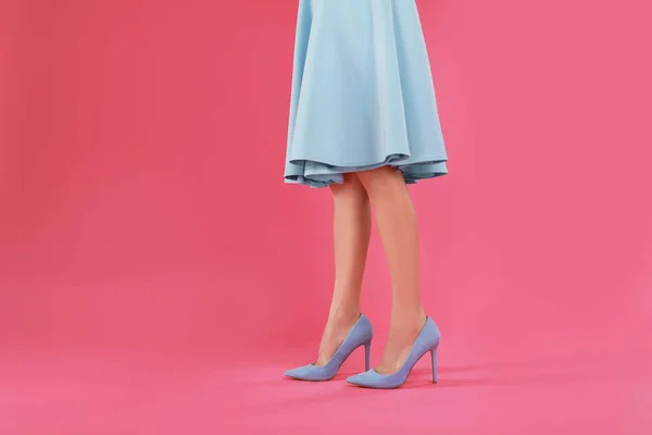 Vrouw in elegante schoenen op roze achtergrond — Stockfoto