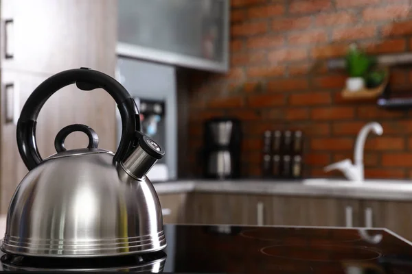 Modern kettle with whistle on stove in kitchen, space for text — Stock Photo, Image