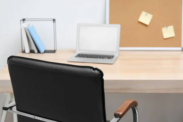 Stylish workplace interior with office chair and wooden table — Stock Photo, Image