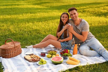 Mutlu çift güneşli bir günde parkta piknik yapıyor.