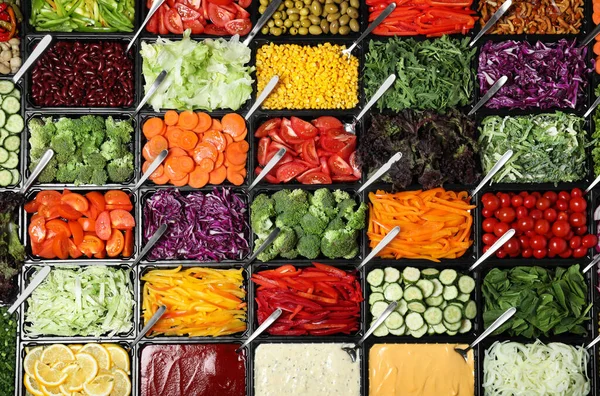 Salad bar with different fresh ingredients as background, top view — Stock Photo, Image