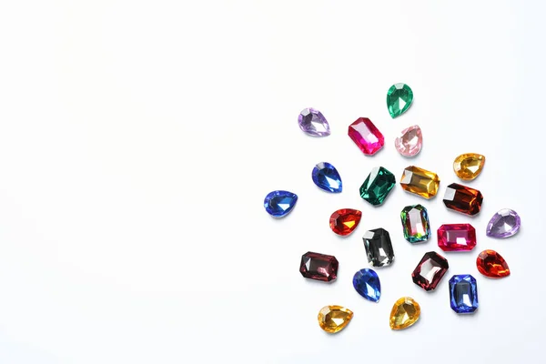 Different beautiful gemstones on white background, top view — Stock Photo, Image