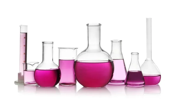 Laboratory glassware with purple liquid on white background — Stock Photo, Image