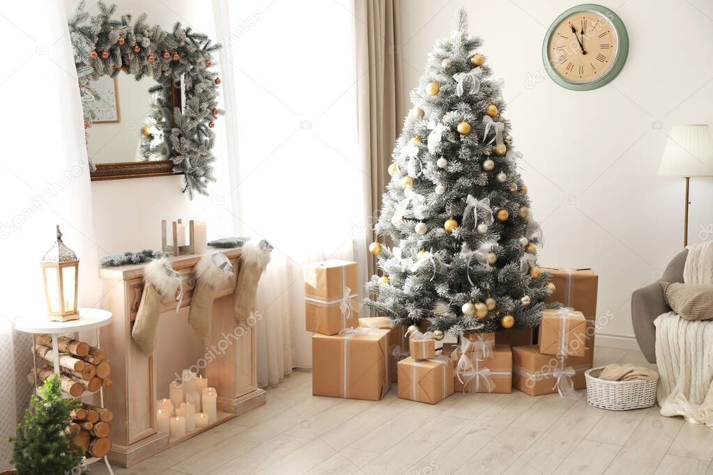 Stylish Christmas interior with beautiful decorated tree and fireplace