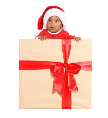 Festively dressed African-American baby in Christmas gift box on white background clipart