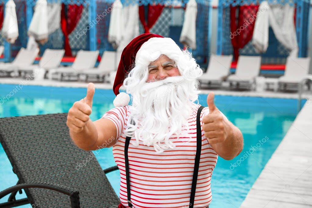 Authentic Santa Claus near swimming pool at resort