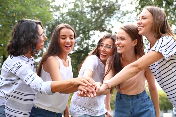 Happy women putting hands together outdoors on sunny day. Girl power concept — Stock Photo, Image