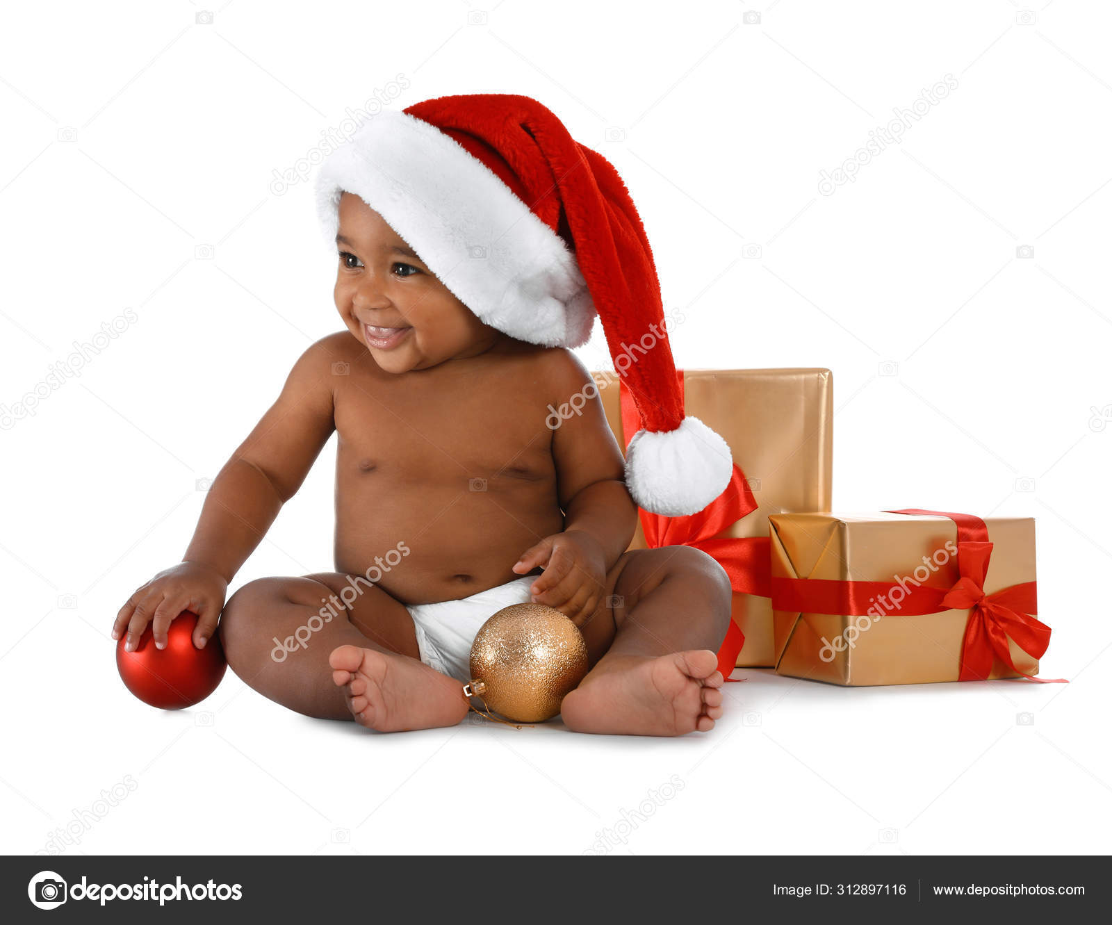 Cute African American baby wearing Santa hat with Christmas gifts