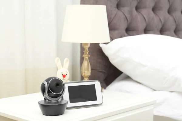 Baby monitor with camera and toy on table in bedroom, space for text. Video nanny — ストック写真