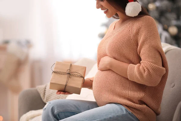 Šťastná těhotná žena s vánoční dárkovou krabicí doma, detailní záběr. Očekává se dítě — Stock fotografie