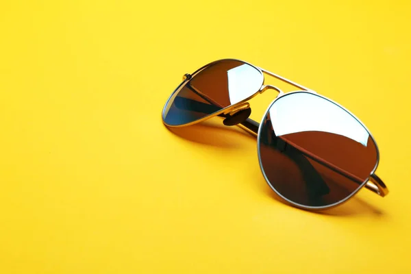 Stylish sunglasses on yellow background, space for text. Fashionable accessory — Stock Photo, Image