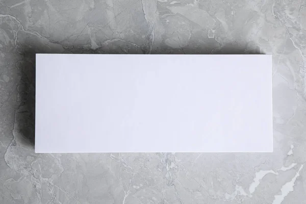 Blank palm card on light grey marble background, top view. Mock up for design — Stock Photo, Image