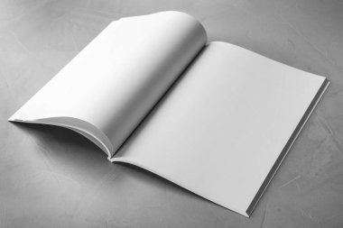 Blank open book on light grey stone background. Mock up for design clipart