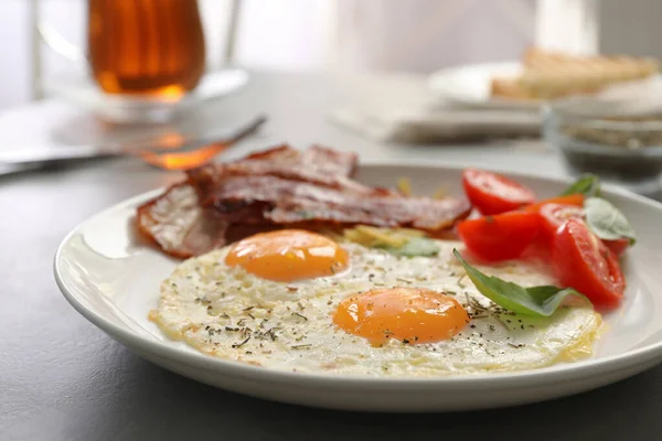 Petit déjeuner savoureux avec œufs frits sur table grise, gros plan — Photo