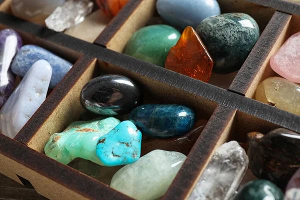 Box with different beautiful gemstones on table, closeup — Stock Photo, Image