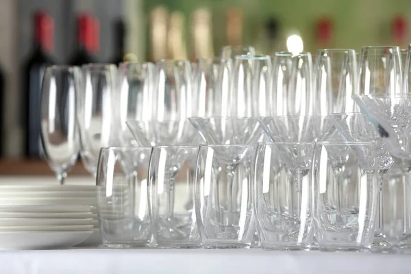 Set of empty glasses and dishware on table indoors — Stock Photo, Image