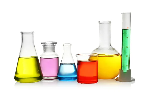 Laboratory glassware with colorful liquids on white background — Stock Photo, Image