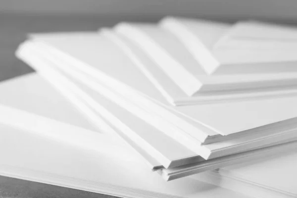 Stack of blank paper on grey table, closeup — Stockfoto