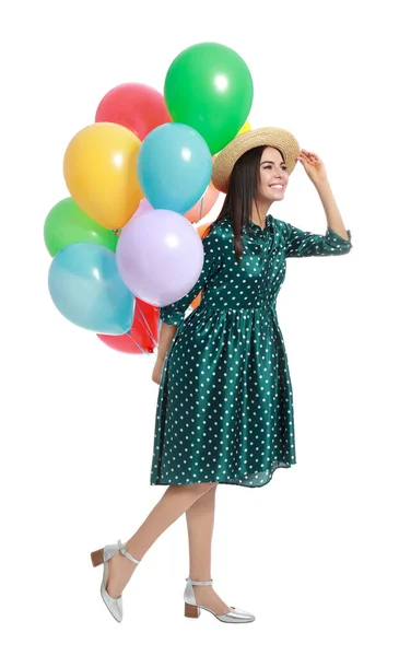 Молодая женщина держит кучу разноцветных воздушных шаров на белом фоне — стоковое фото