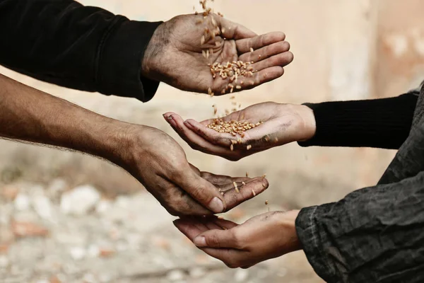 Poor homeless people sharing food outdoors, closeup — Stock Photo, Image