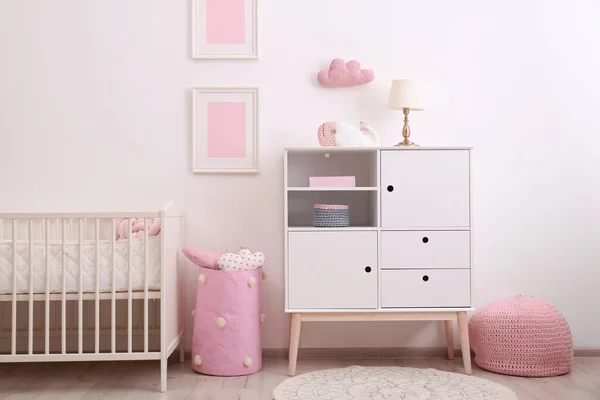 Nursery interior with comfortable bed and cabinet — ストック写真